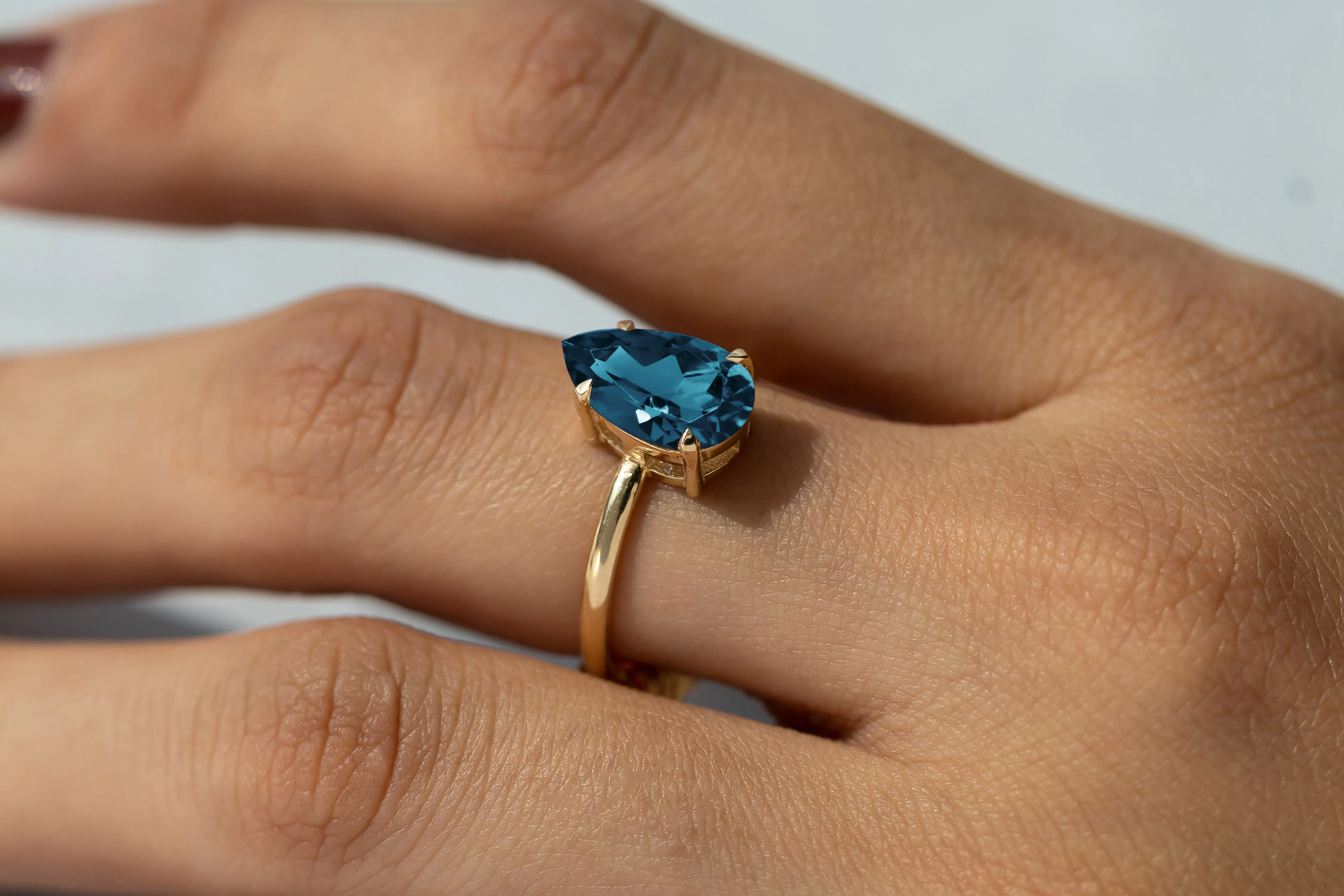 Cameo Teardrop Blue Topaz Solitaire Ring
