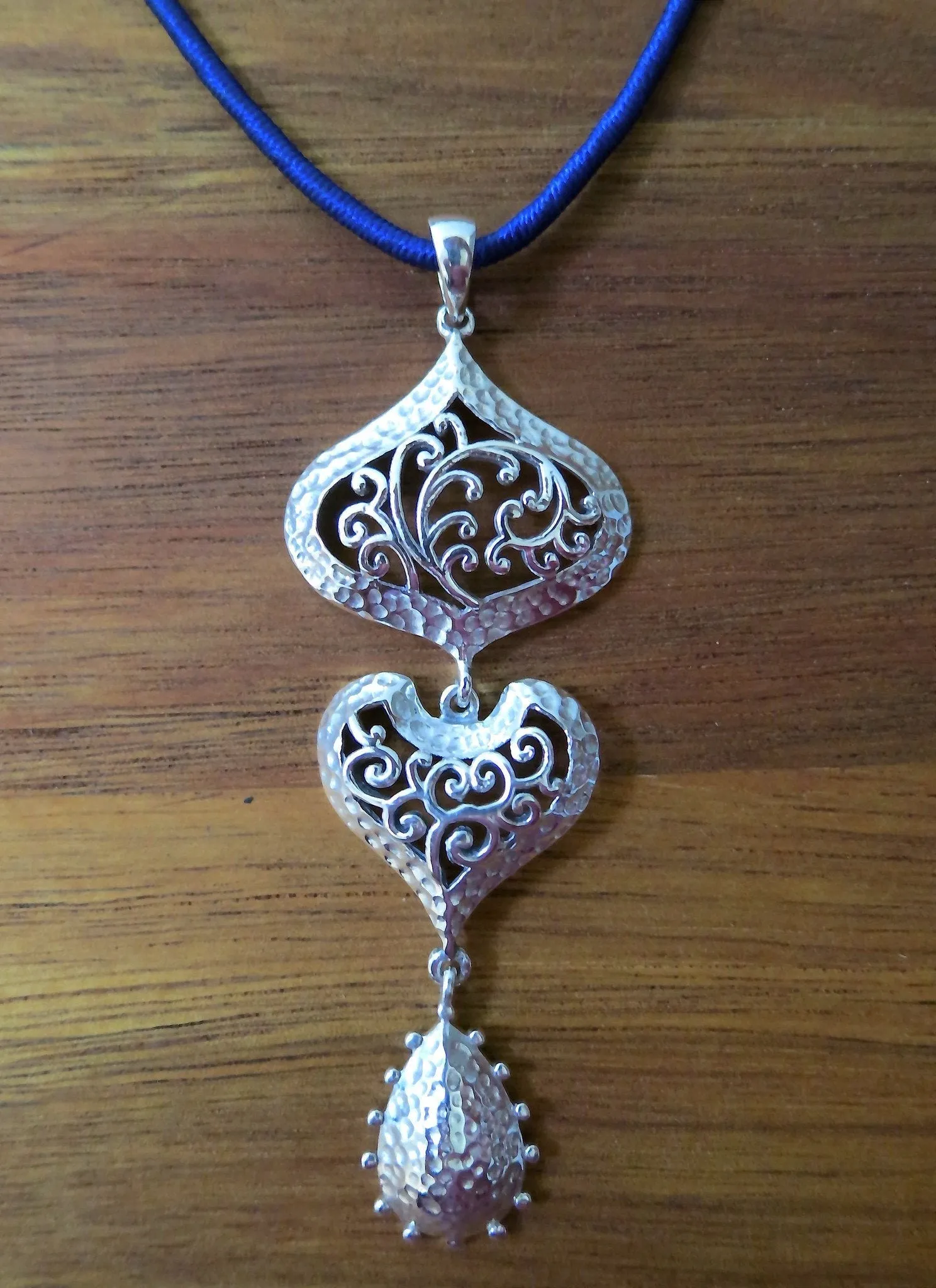 Elegant, 3-tier, long Kutch-inspired hammer finish pendant with jali work